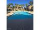 Expansive community pool surrounded by palm trees and comfortable seating areas at 8985 S Durango Dr # 1154, Las Vegas, NV 89113