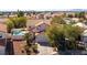 An aerial view of a home with a sparkling pool, mature landscaping, and a two car driveway at 1011 Pearl Marble Ave, North Las Vegas, NV 89081