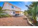 Spacious backyard with a covered patio area, desert landscaping, and ample room for outdoor living at 1011 Pearl Marble Ave, North Las Vegas, NV 89081