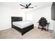 Bedroom featuring a ceiling fan, a desk with a computer and chair and a bed with a dark wood frame at 1011 Pearl Marble Ave, North Las Vegas, NV 89081