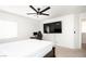 Bedroom with a dark wood bed, a ceiling fan, and a wall mounted flat screen TV at 1011 Pearl Marble Ave, North Las Vegas, NV 89081