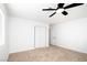 A clean, bright bedroom with a ceiling fan, carpeted floor, and closet for lots of storage at 1011 Pearl Marble Ave, North Las Vegas, NV 89081