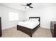 This is a bedroom with a modern bed frame and a black ceiling fan with tan carpet at 1011 Pearl Marble Ave, North Las Vegas, NV 89081