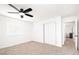 This bedroom offers a ceiling fan, neutral walls, a window, and double door closet at 1011 Pearl Marble Ave, North Las Vegas, NV 89081