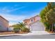 Two-story home with neutral stucco, a red tile roof, and a two-car garage at 1011 Pearl Marble Ave, North Las Vegas, NV 89081