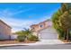 Charming two-story home with a tile roof, desert landscaping, and a two car garage at 1011 Pearl Marble Ave, North Las Vegas, NV 89081