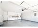 Garage with epoxy flooring, white cabinets, and door to house at 1011 Pearl Marble Ave, North Las Vegas, NV 89081