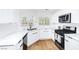 Modern kitchen featuring white cabinets, quartz countertops, and stainless steel appliances at 1011 Pearl Marble Ave, North Las Vegas, NV 89081