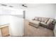 Open loft area featuring neutral carpet, a ceiling fan and a comfortable gray sofa at 1011 Pearl Marble Ave, North Las Vegas, NV 89081