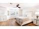 Bright main bedroom featuring wood floors, windows, ceiling fan and modern furniture at 1011 Pearl Marble Ave, North Las Vegas, NV 89081
