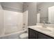 Well-lit bathroom with a shower-tub combo, vanity with storage, and tile flooring at 10116 Nash Peak Ave, Las Vegas, NV 89166