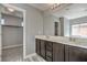 Well-lit bathroom featuring a double sink vanity and access to a walk-in closet for ample storage at 10116 Nash Peak Ave, Las Vegas, NV 89166