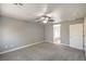 Comfortable bedroom featuring plush carpet and neutral paint, and a bathroom with plank flooring at 10116 Nash Peak Ave, Las Vegas, NV 89166