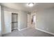 Gray bedroom featuring a spacious closet, neutral carpet, and a paneled door at 10116 Nash Peak Ave, Las Vegas, NV 89166