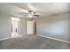 Comfortable bedroom with plush carpet and neutral paint, and a view into a bathroom with plank flooring at 10116 Nash Peak Ave, Las Vegas, NV 89166
