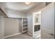 Walk-in closet with carpet, ample shelving, and a view into the primary bathroom at 10116 Nash Peak Ave, Las Vegas, NV 89166