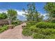 A scenic brick walking path featuring green shrubs and landscaping in the community park at 10116 Nash Peak Ave, Las Vegas, NV 89166