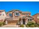 Charming two-story home with a well-manicured front yard, two-car garage, and inviting entrance at 10116 Nash Peak Ave, Las Vegas, NV 89166