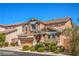 Inviting two-story residence with neat landscaping, an attached two-car garage, and a welcoming front facade at 10116 Nash Peak Ave, Las Vegas, NV 89166