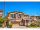 Attractive two-story home featuring a well-maintained front lawn, a two-car garage, and classic architectural details at 10116 Nash Peak Ave, Las Vegas, NV 89166