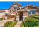 Inviting two-story home with a well-manicured lawn and an attached two-car garage at 10116 Nash Peak Ave, Las Vegas, NV 89166