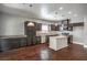 Modern kitchen with dark cabinets, granite countertops, a central island, and stainless steel appliances at 10116 Nash Peak Ave, Las Vegas, NV 89166