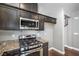 Close-up view of a modern kitchen's stainless steel stove, oven, and microwave over granite counters at 10116 Nash Peak Ave, Las Vegas, NV 89166