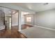 Open-concept living room with hardwood floors, plush carpet, and plenty of natural light at 10116 Nash Peak Ave, Las Vegas, NV 89166