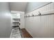 Cozy mudroom entry with wainscoting, coat hooks, bench, and adjacent shelving at 10116 Nash Peak Ave, Las Vegas, NV 89166