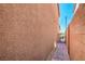 The house features a narrow walkway on the side, leading to a gate and offering a private entry point at 10116 Nash Peak Ave, Las Vegas, NV 89166