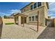 A well-maintained backyard with a covered patio and low maintenance landscaping at 10271 Bark Pine Ct, Las Vegas, NV 89166