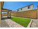 Spacious backyard featuring pavers, gravel, and artificial grass at 10271 Bark Pine Ct, Las Vegas, NV 89166