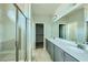 Bathroom featuring double sinks, a walk-in shower, and modern fixtures at 10271 Bark Pine Ct, Las Vegas, NV 89166