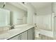 Well-lit bathroom with a sleek gray vanity, white countertop and large mirror at 10271 Bark Pine Ct, Las Vegas, NV 89166