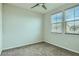 Bedroom with three windows, carpet and ceiling fan at 10271 Bark Pine Ct, Las Vegas, NV 89166