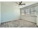 Bedroom featuring carpeting, ceiling fan, and multiple windows at 10271 Bark Pine Ct, Las Vegas, NV 89166