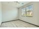 Bright bedroom with tile flooring and two windows at 10271 Bark Pine Ct, Las Vegas, NV 89166