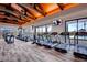 Bright fitness center featuring treadmills and elliptical machines and exposed beam ceiling at 10271 Bark Pine Ct, Las Vegas, NV 89166