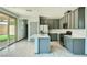 Modern kitchen featuring an island, stainless steel appliances, and gray cabinetry at 10271 Bark Pine Ct, Las Vegas, NV 89166