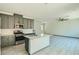 Modern kitchen with stainless steel appliances and quartz countertops with open living space at 10271 Bark Pine Ct, Las Vegas, NV 89166