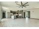 Open floor plan featuring a modern kitchen and spacious living area with tile floors at 10271 Bark Pine Ct, Las Vegas, NV 89166