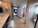 Bright bathroom with double sinks, tile flooring, and a glass-enclosed shower at 10383 Andele Ave, Las Vegas, NV 89166