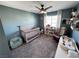 Charming Bedroom with a crib, rocking chair, and soft blue walls at 10383 Andele Ave, Las Vegas, NV 89166