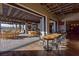 Community clubhouse dining area featuring indoor/outdoor seating, wooden tables, and mountain views at 10383 Andele Ave, Las Vegas, NV 89166