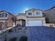 Inviting two-story home featuring neutral stucco, paver driveway, covered porch and a convenient two-car garage at 10383 Andele Ave, Las Vegas, NV 89166