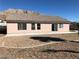 Home backyard with desert landscaping, complete with a concrete patio at 1083 Sterling Peak St, Las Vegas, NV 89110
