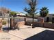 A quaint fenced yard with desert landscaping and mature shade tree at 1083 Sterling Peak St, Las Vegas, NV 89110
