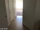 Hallway with tiled flooring leading to bedrooms, creating an inviting flow with a series of closet doors at 1083 Sterling Peak St, Las Vegas, NV 89110
