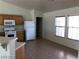 Kitchen with wooden cabinets, white appliances, and tile flooring at 1083 Sterling Peak St, Las Vegas, NV 89110