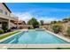 Inviting backyard with pool, outdoor kitchen, and patio, perfect for entertaining or relaxing at 11 Morninglow Pass, Henderson, NV 89052